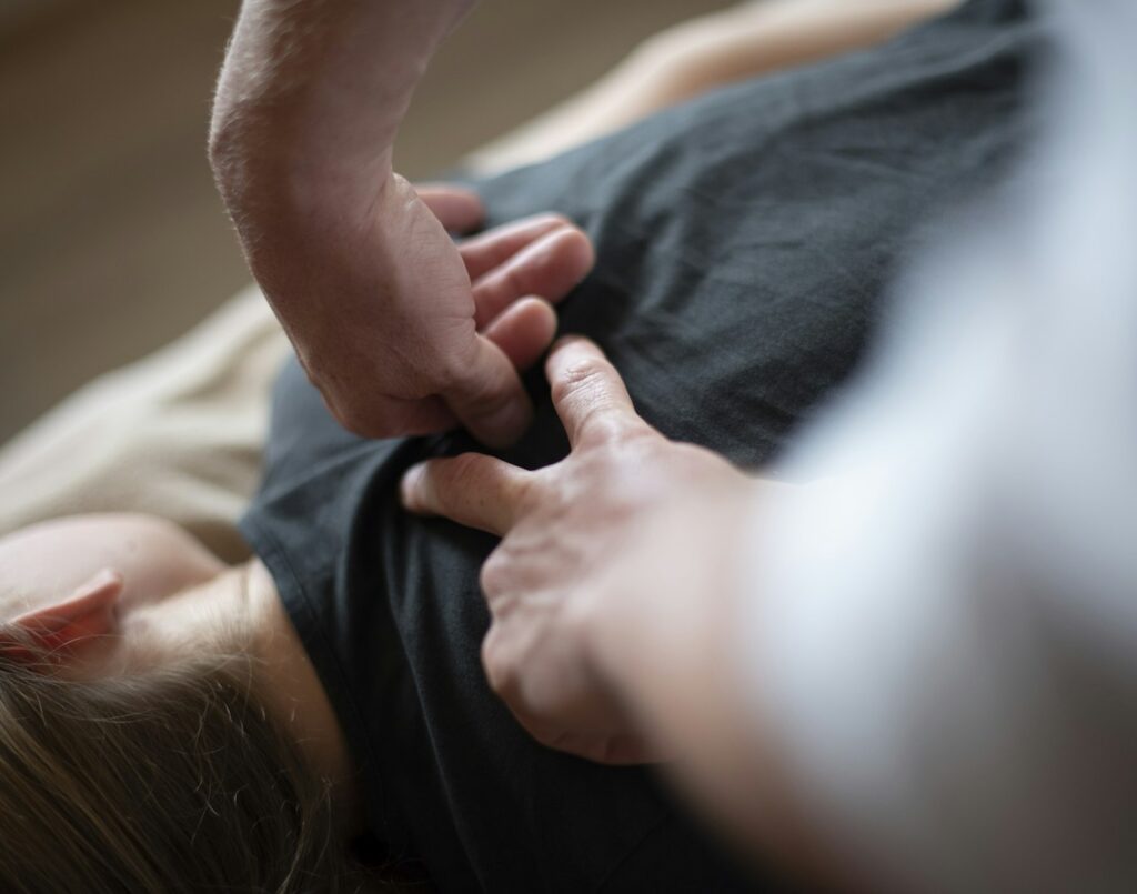 Chiropractor applying hands-on pressure to a patient's back
