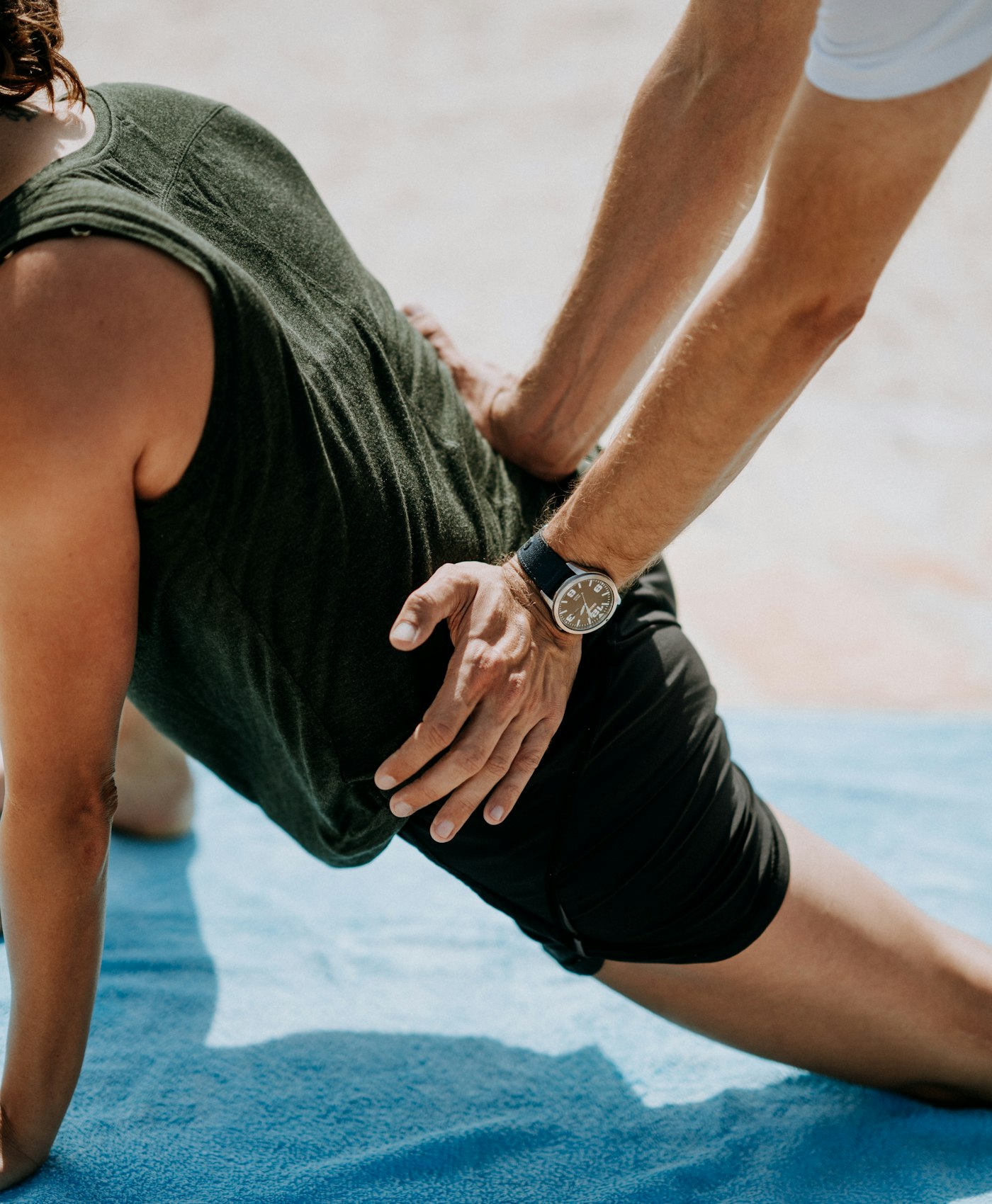 Chiropractor assessing a patient's back and movement before a training program