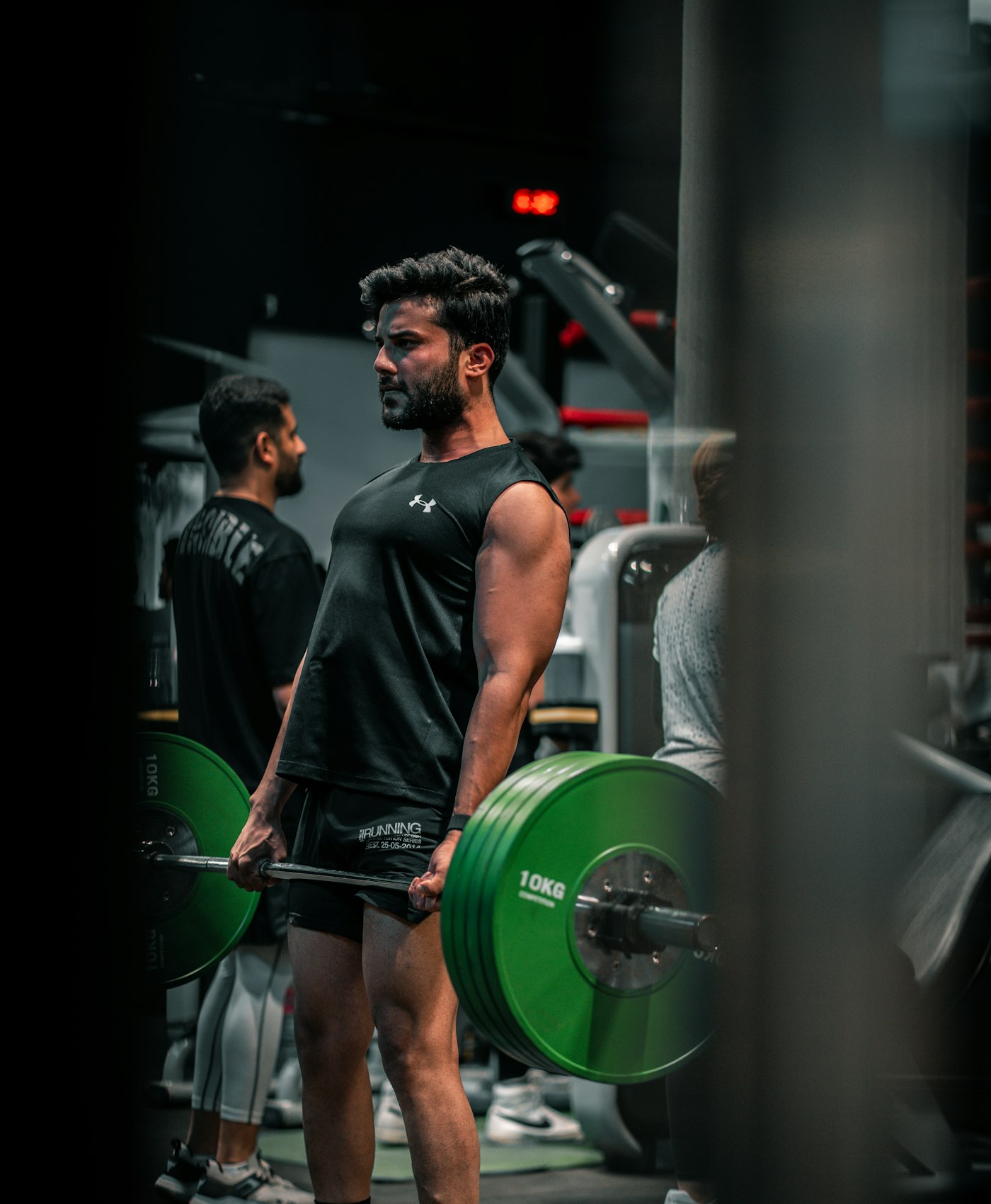 Man performing a barbell lift as part of a strength training program