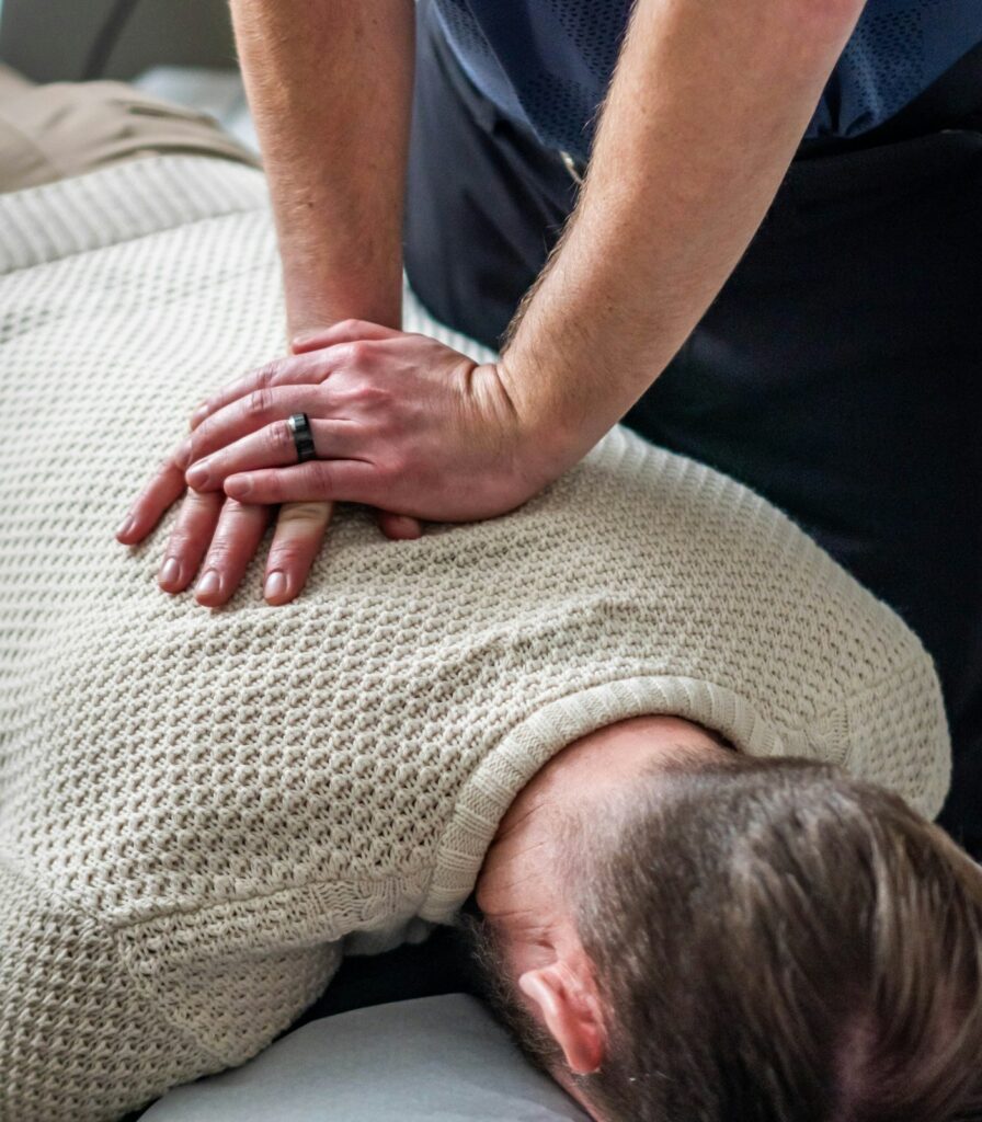 On-site chiropractic care: chiropractor adjusting a patient’s neck and upper back