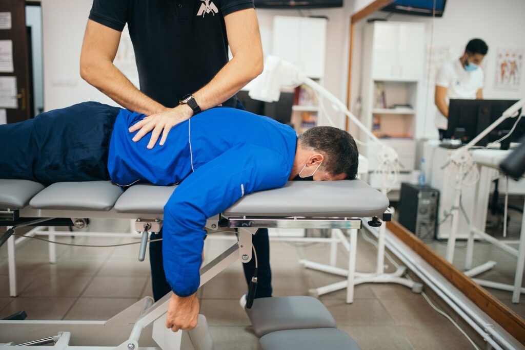 Chiropractor adjusting a patient’s lower back