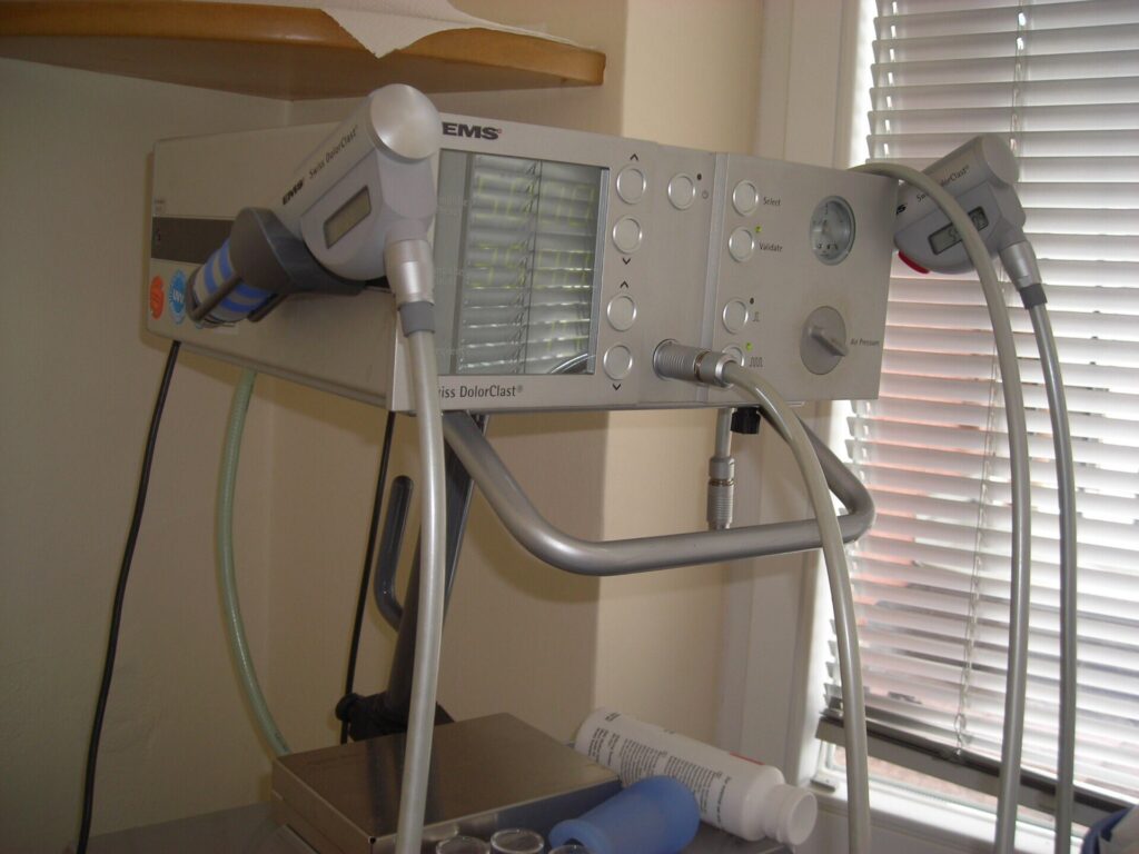 Extracorporeal shockwave therapy device with a handheld applicator and control unit